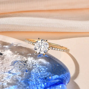 Diamond engagement ring featuring a 14K yellow gold moissanite band with accent diamonds