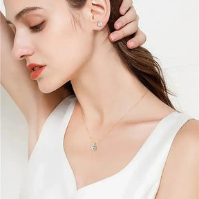 Delicate silver necklace with lab grown diamond pendant worn by woman in white top