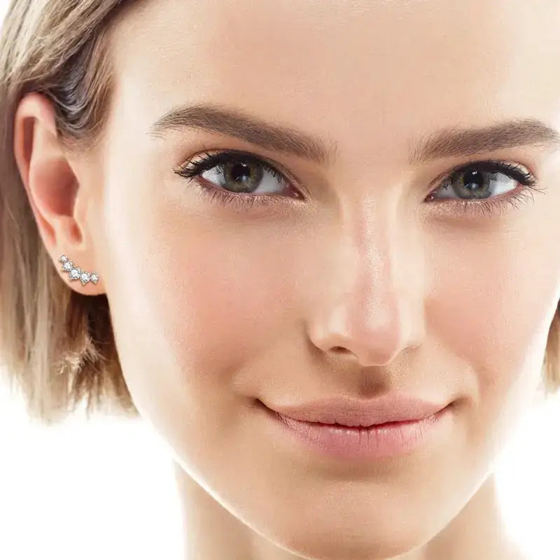 Close-up portrait of a woman with blonde hair showcasing elegant gold plated moissanite jewelry