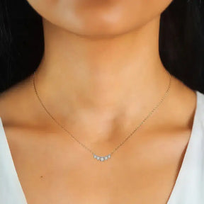 Delicate gold plated moissanite necklace featuring three small diamond-like stones