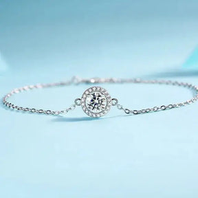 Delicate silver moissanite diamond bracelet with round diamond centerpiece and smaller stones