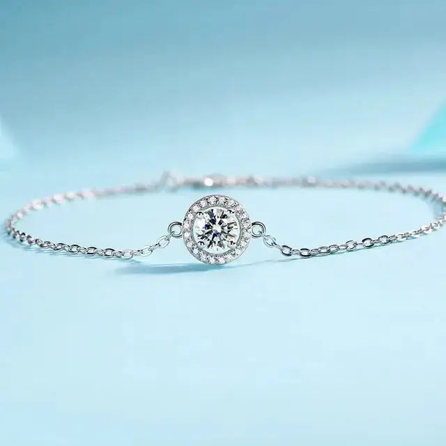 Delicate silver moissanite diamond bracelet with round diamond centerpiece and smaller stones