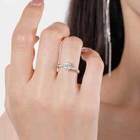 Diamond engagement ring on woman’s finger featuring a 1ct Moissanite diamond in 18k white gold