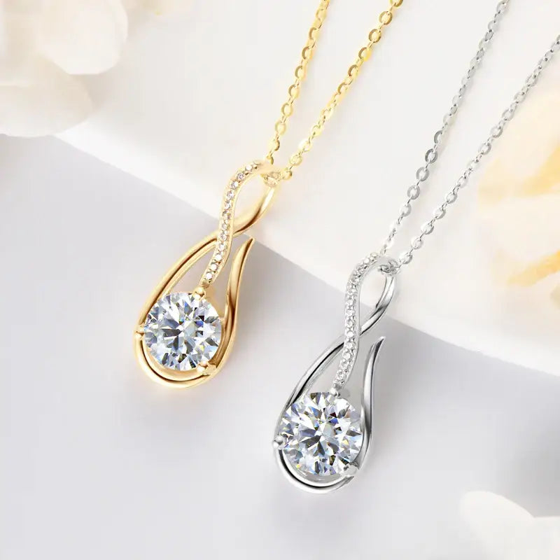 Two teardrop-shaped lab grown diamond pendant necklaces in gold and silver