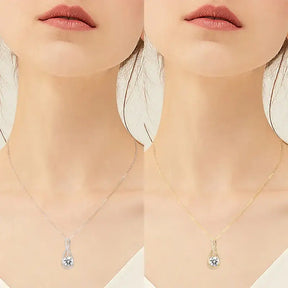 Delicate silver lab grown diamond pendant necklace featuring blue teardrop gemstone