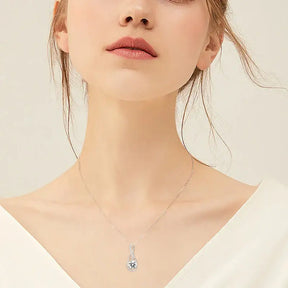 Delicate silver necklace featuring a blue gemstone pendant and lab grown diamond charm