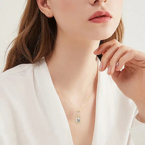 Delicate gold necklace showcasing a lab grown diamond pendant against pale skin