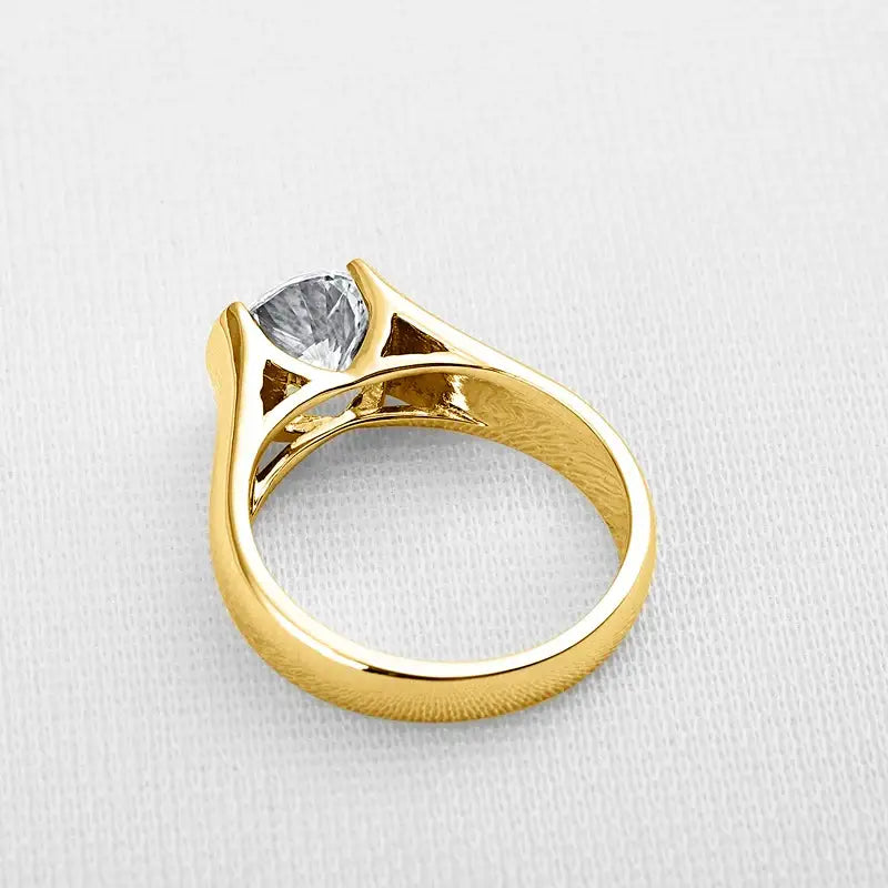 Gold engagement ring featuring a 2-carat moissanite in raised setting of sterling silver elegance