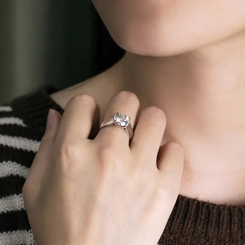 Diamond engagement ring on finger featuring a 2-carat moissanite ring in sterling silver elegance