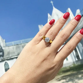 Hand with red nail polish showcasing a 2-carat Moissanite ring in sterling silver elegance