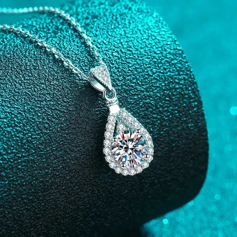 Teardrop-shaped Moissanite diamond pendant on a silver chain for an elegant wedding necklace