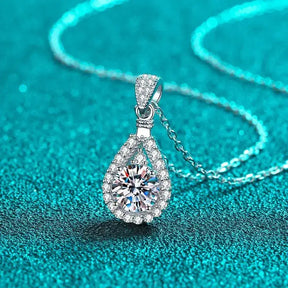 Teardrop-shaped moissanite diamond pendant on a silver chain for an elegant wedding necklace