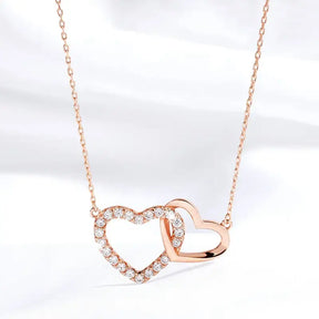 Rose gold double heart Moissanite necklace with diamond outlines and sterling silver elegance