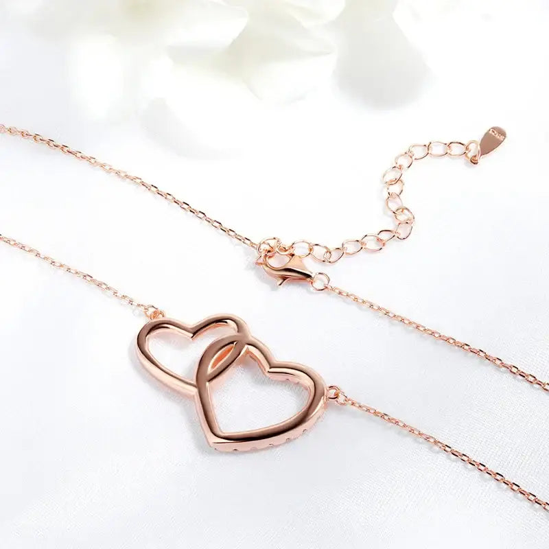 Rose gold interlocking heart Moissanite necklace showcasing double heart design elegance