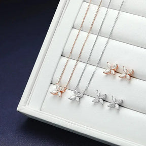 Jewelry display tray featuring rose gold and silver butterfly-shaped moissanite jewelry set