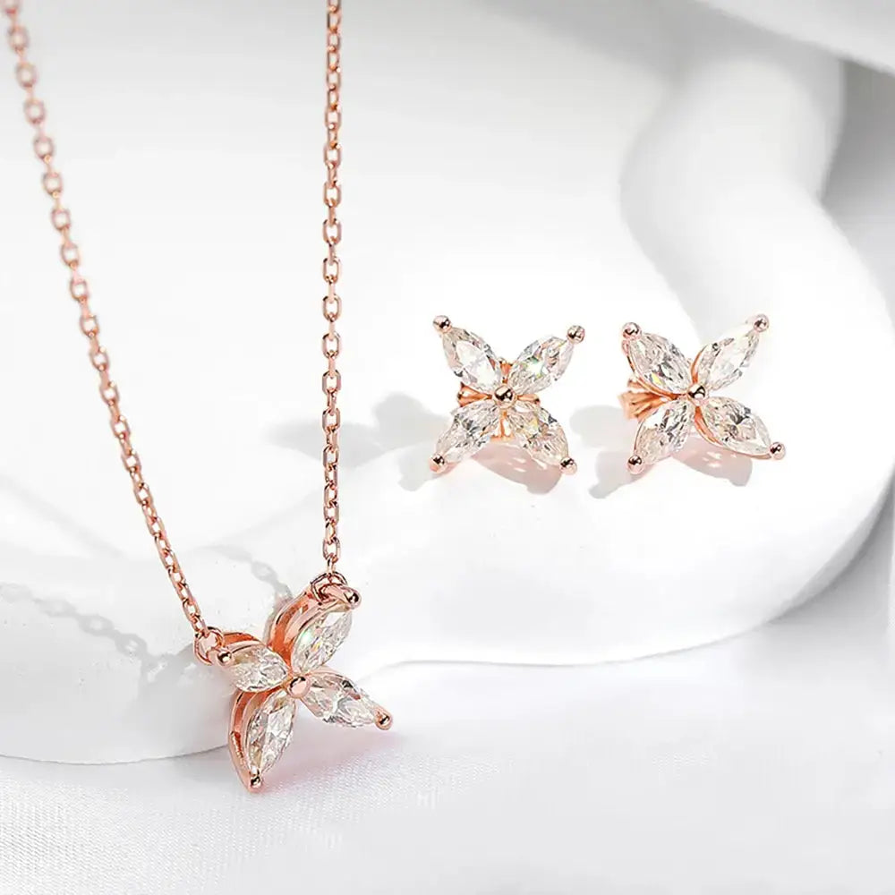 Delicate rose gold jewelry set featuring marquise-cut moissanite stones and floral design