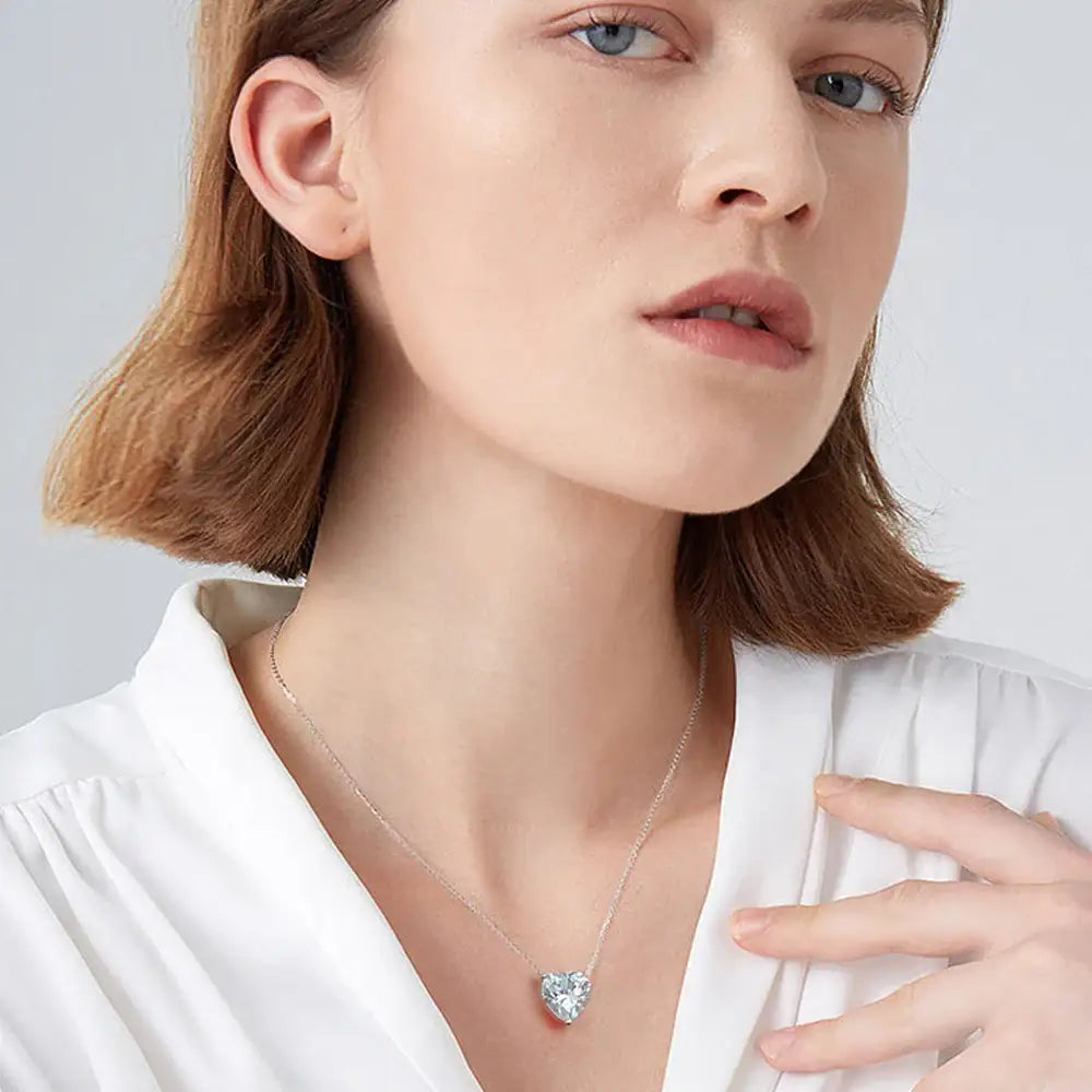 Delicate heart-shaped pendant necklace featuring a blue gemstone in S925 Sterling Silver