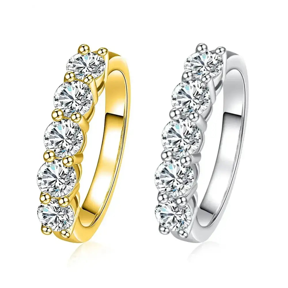 Two diamond eternity rings in yellow and white gold beside a 4mm D Color Moissanite Wedding Band