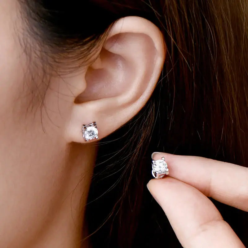 Elegant 5mm Lab Grown Diamond Earrings held near an ear for stylish presentation