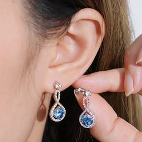 Elegant teardrop earrings featuring blue gemstones and lab grown diamond accents