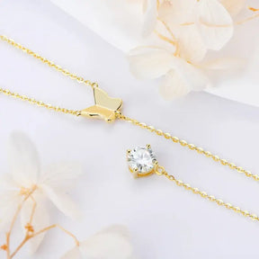 Delicate gold necklace featuring a Lab Grown Diamond butterfly pendant and charm