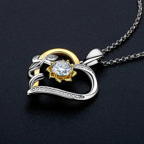 Heart pendant necklace featuring a 5mm moissanite heart set in mixed gold and silver tones