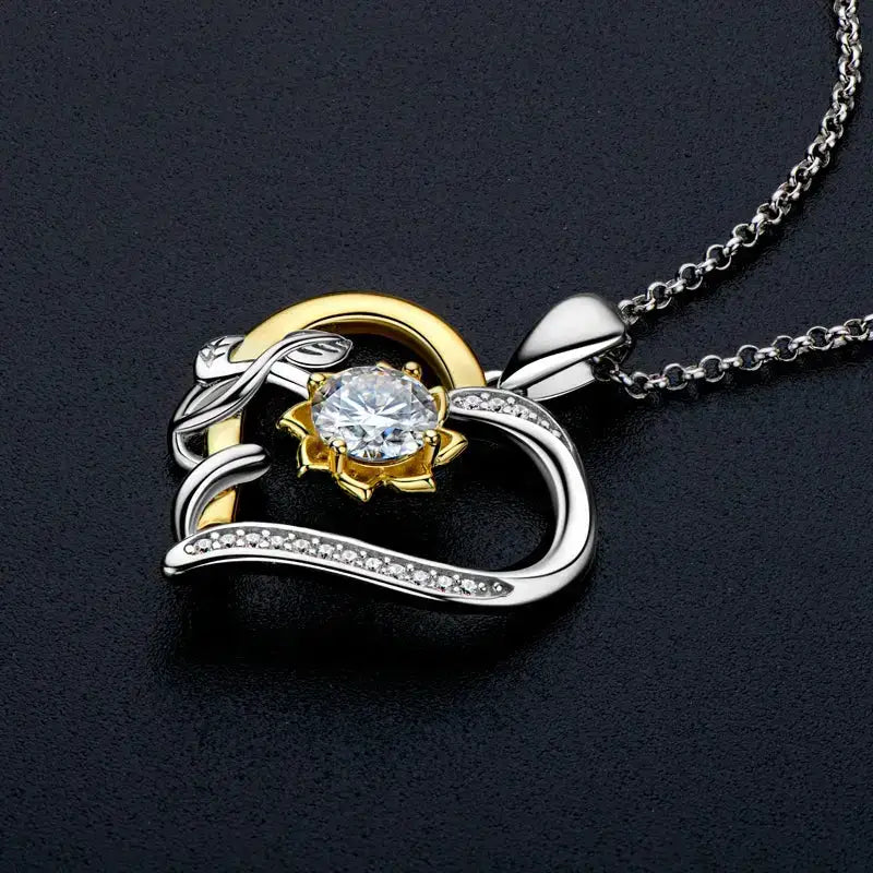 Heart pendant necklace featuring a 5mm moissanite heart set in mixed gold and silver tones