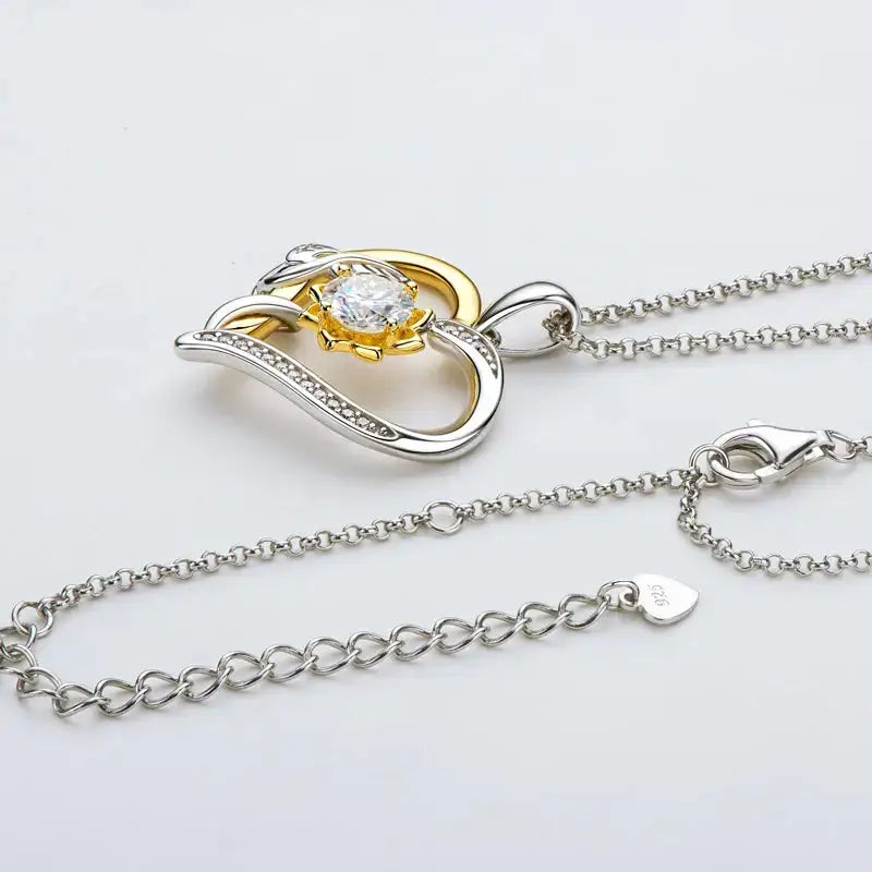 Heart pendant necklace featuring 5mm Moissanite, set in silver and gold tones