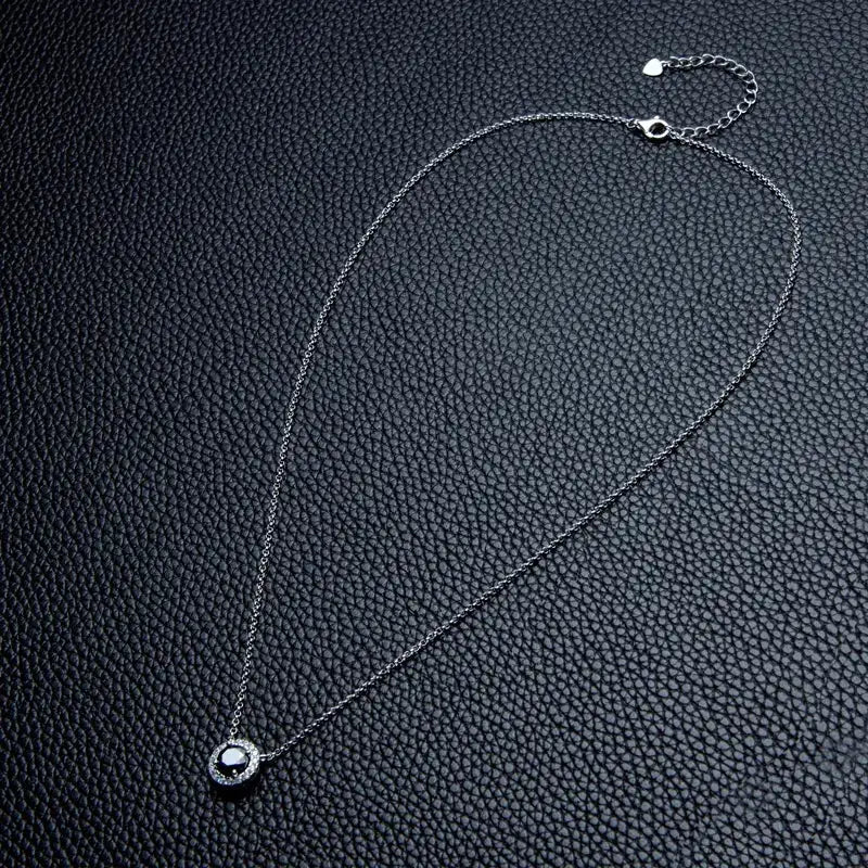 Delicate silver Moissanite pendant on a necklace from Telles Jewelry, showcasing elegance