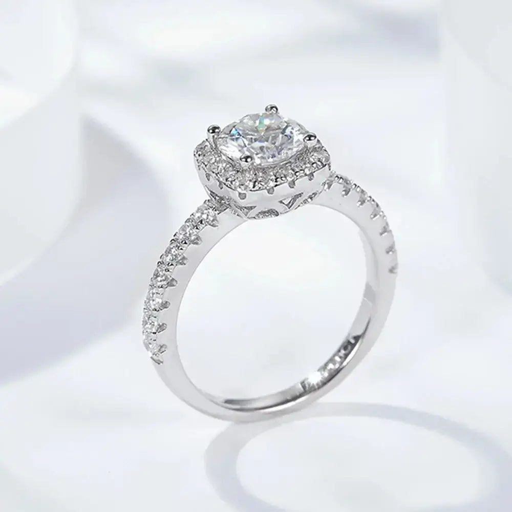 Diamond engagement ring featuring a cushion-cut center stone and sterling silver brilliance