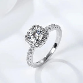 Cushion-cut moissanite diamond engagement ring in sterling silver with a sparkling halo