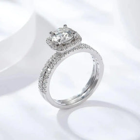 Diamond engagement ring showcasing a round center stone in a halo setting with pave band