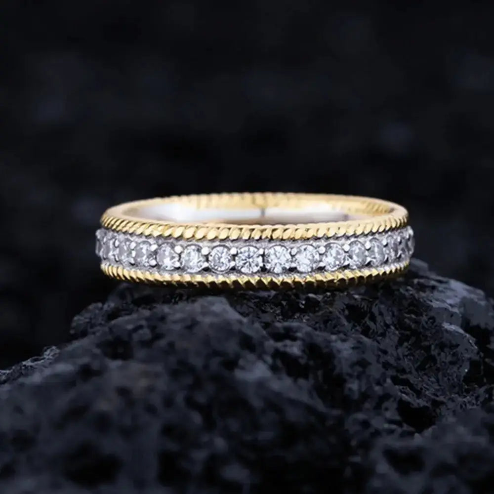 Gold and diamond eternity ring showcasing a textured edge on a sterling silver created moissanite band