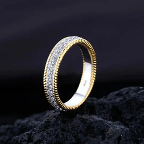 Gold ring featuring intricate edge detailing and sterling silver created moissanite diamonds