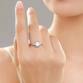 Diamond engagement ring on finger featuring a 925 Sterling Silver Emerald Cut Moissanite design