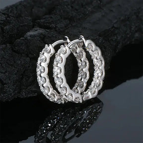 Pair of sterling silver moissanite stud earrings with ornate scalloped hoop design