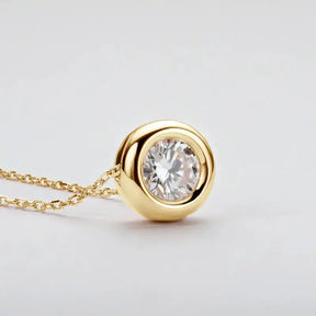 Gold pendant necklace with round cut Moissanite in bezel setting on sterling silver chain