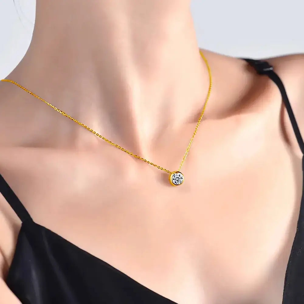 Gold necklace featuring a round cut Moissanite gemstone in 925 Sterling Silver