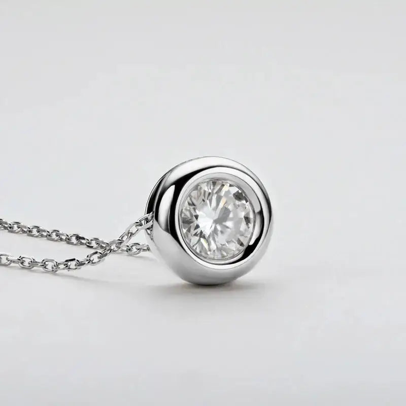 Diamond solitaire pendant necklace featuring a round cut Moissanite gem in sterling silver