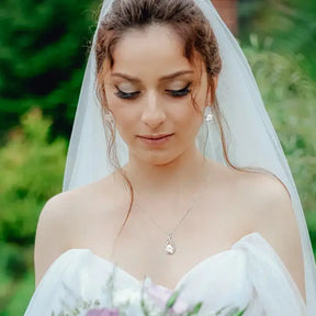 Bride in white wedding dress with veil showcasing 925 Sterling Silver Pearl Jewelry Set