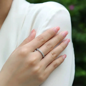 Delicate 925 Sterling Silver sparkling ring with moissanite diamonds worn on a finger