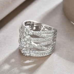 Ornate silver sparkling moissanite diamond ring featuring intricate intertwined bands