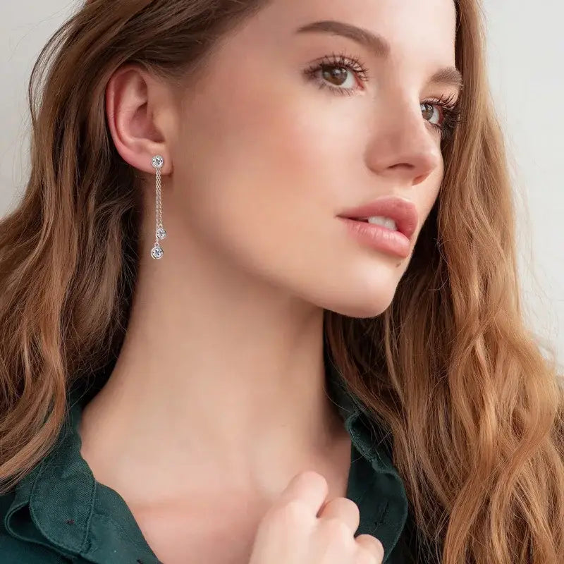 Woman in green top showcasing All Lab Grown Diamond Drop Earrings with Detachable Double Chain