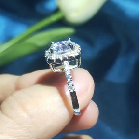 Brilliant Moissanite Halo Engagement Ring featuring a cushion-cut center stone and halo