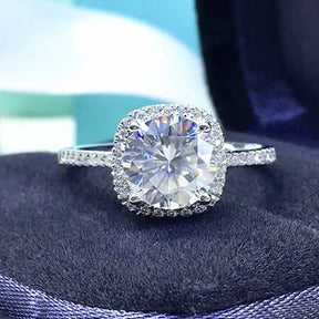 Cushion-cut diamond engagement ring with brilliant moissanite halo setting and pave band