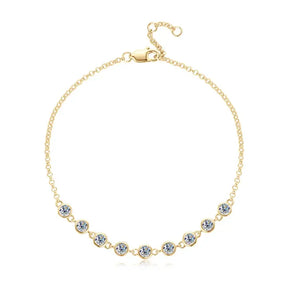 Delicate gold chain necklace with light blue gemstones, a complement to Telles Jewelry