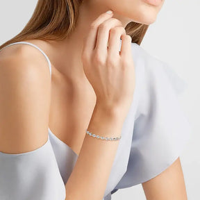 Delicate silver bracelet with moissanite diamonds worn by a woman from Telles Jewelry