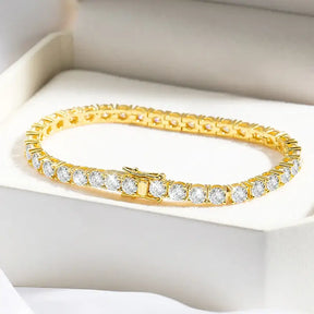 Gold tennis bracelet featuring color lab grown diamonds in a stunning line design