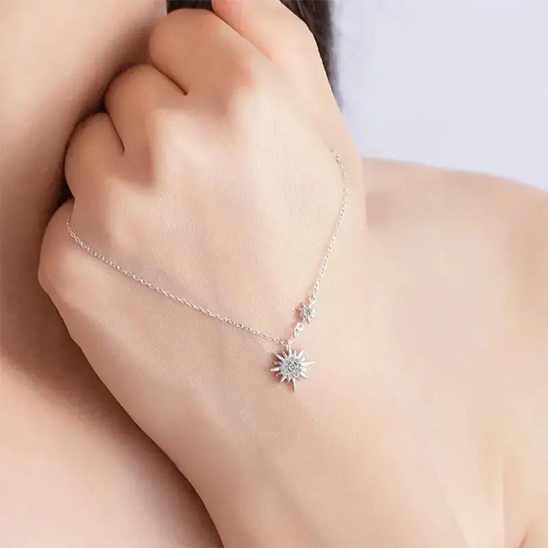 Delicate silver necklace featuring a sunburst moissanite diamond pendant for elegance