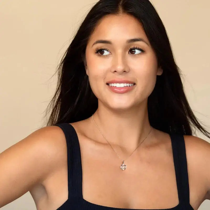 Young woman with dark hair smiling, showcasing a Dancing Pendant Necklace in Sterling Silver Heart